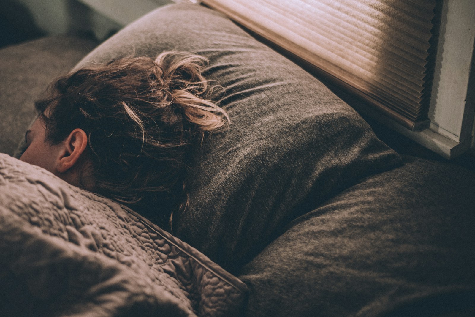 Peaceful sleep under warm blanket — sleep quality is Level 1 intervention